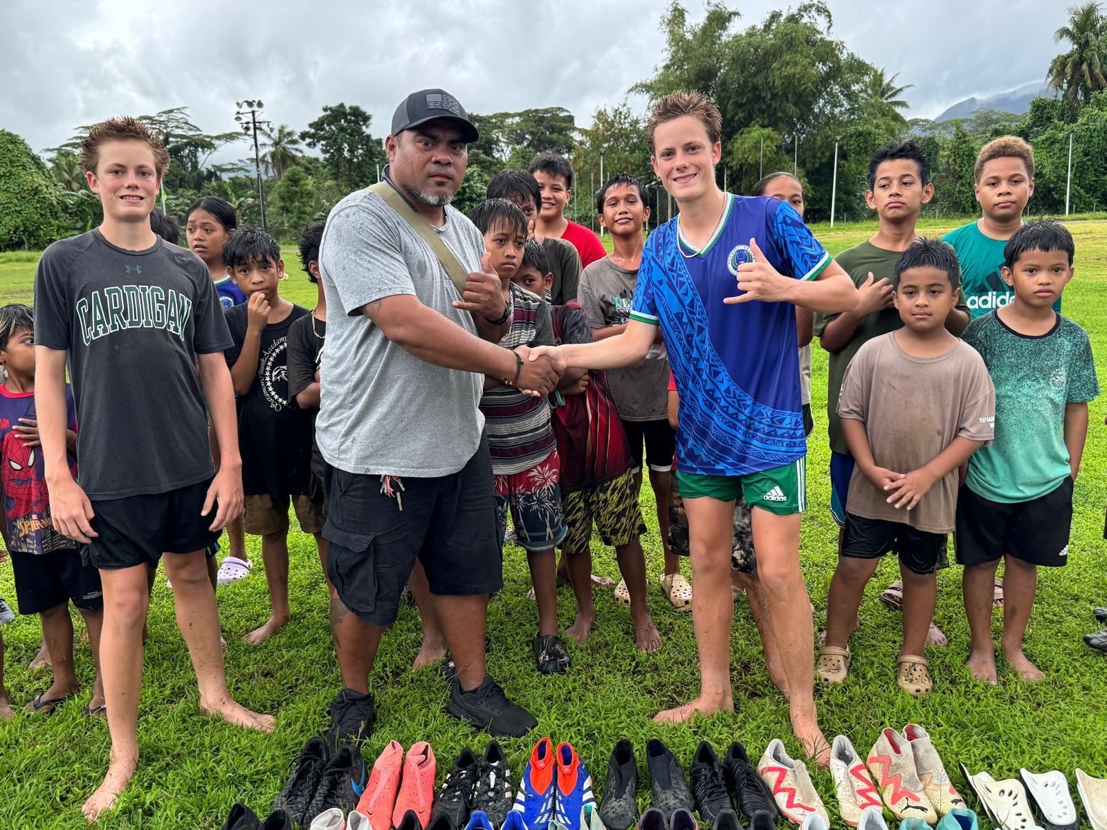 CleatsforKids equipment handoff to a youth football program