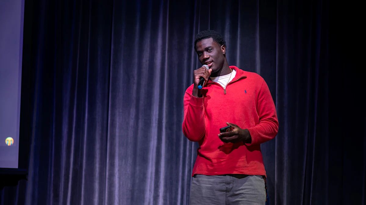 A student presenter pitching on stage at Tiger Cage