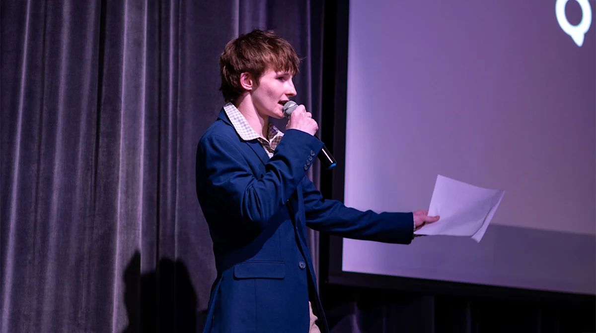 A student presenter pitching on stage at Tiger Cage