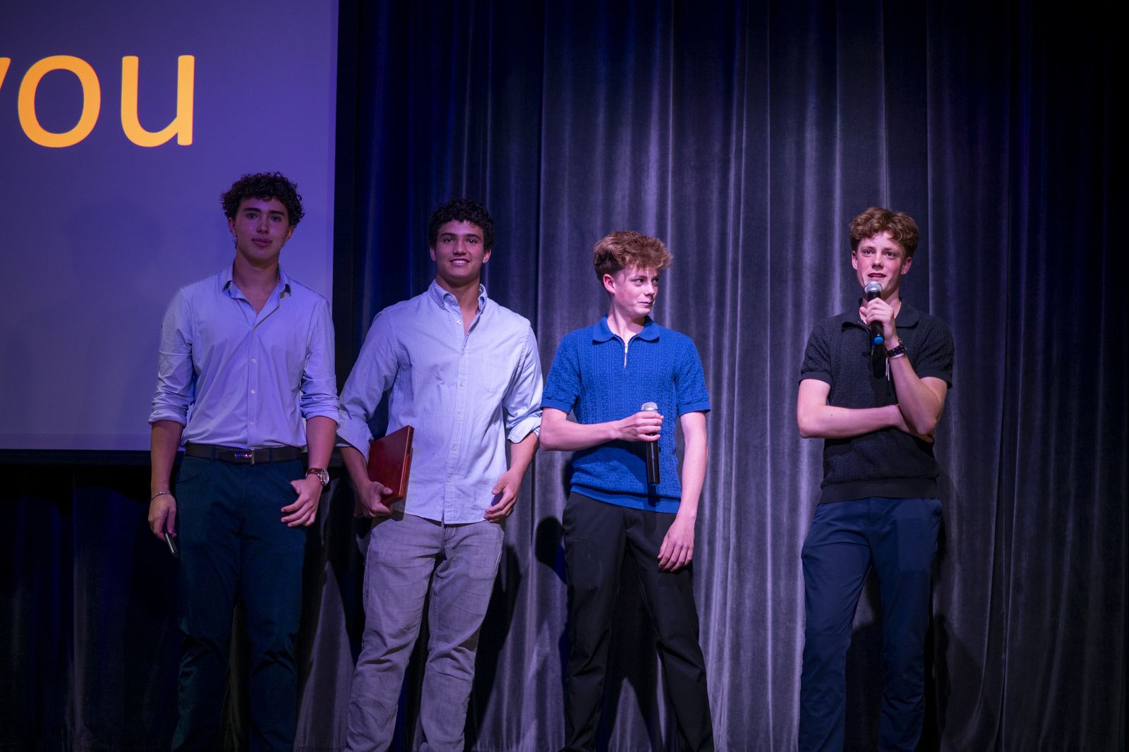 Student presenters on stage at the Tiger Cage finale